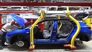 A man works on the assembling of an Opel "Grandland X" SUV car at Opel's plant in Eisenach, eastern Germany, on August 28, 2019. (Photo by Martin Schutt / dpa / AFP) / Germany OUT
