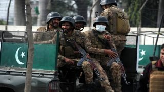 epa11210496 Pakistani security officials stand guard at the scene of a blast on a roadside in Peshawar, Pakistan, 10 March 2024. According to the police, two individuals have lost their lives in a blast that occurred in Peshawar. The explosion, which took place near the Board Bazaar area, also left one person injured, who has since been hospitalized at Khyber Teaching Hospital. Peshawar, serving as the capital of Khyber Pakhtunkhwa province, witnessed this tragic incident, highlighting ongoing security concerns in the region. EPA/ARSHAD ARBAB